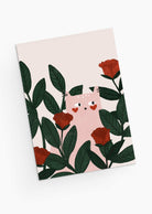 The Lovey Dovey Cat Greeting Card by Mimi & August features a cat with heart-shaped cheeks among green leaves and red roses, ideal for a Valentine's Day greeting on a crisp white background.