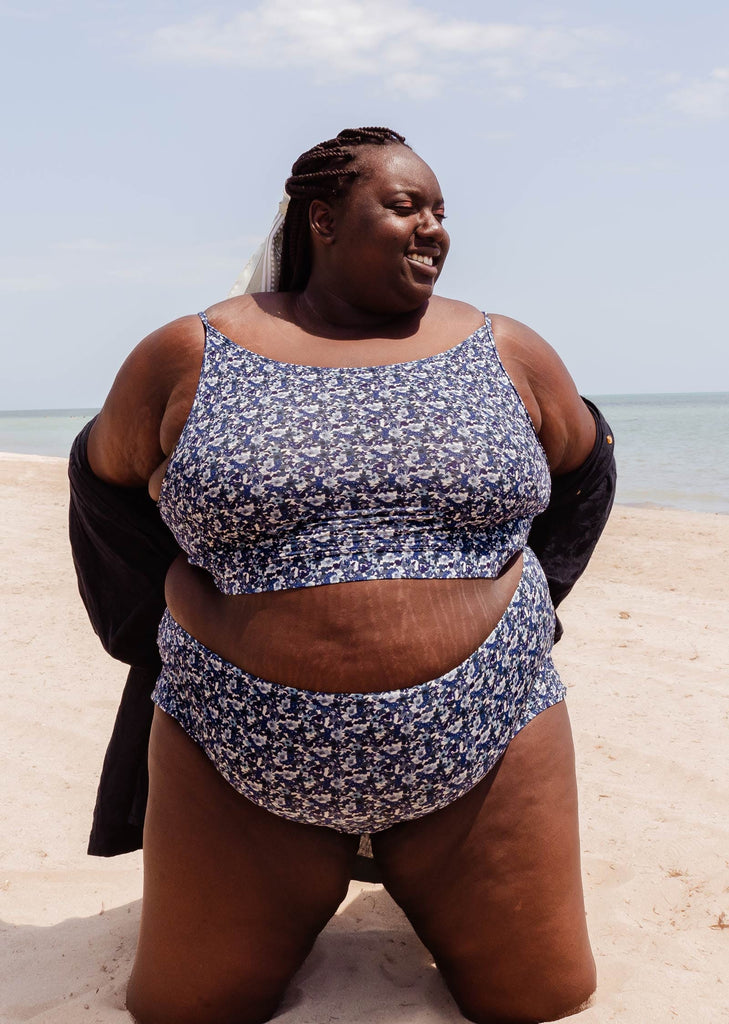 A beautiful woman in a Mango Moonflower Bralette Bikini Top on a beach.