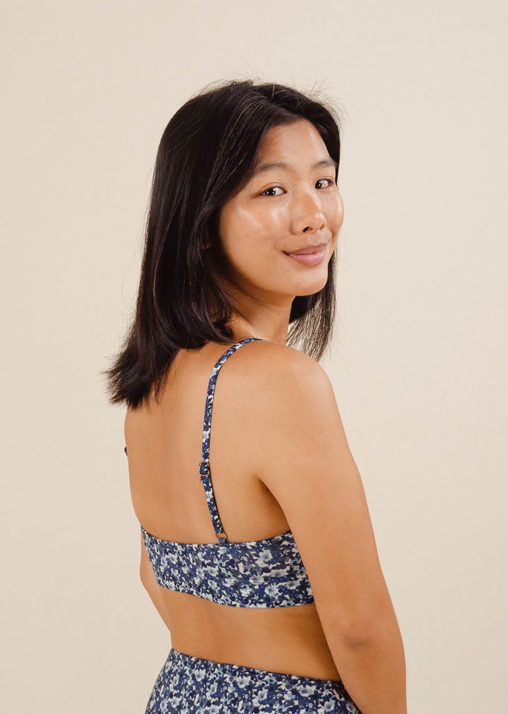 A smiling woman in a Mango Moonflower Bralette Bikini Top.