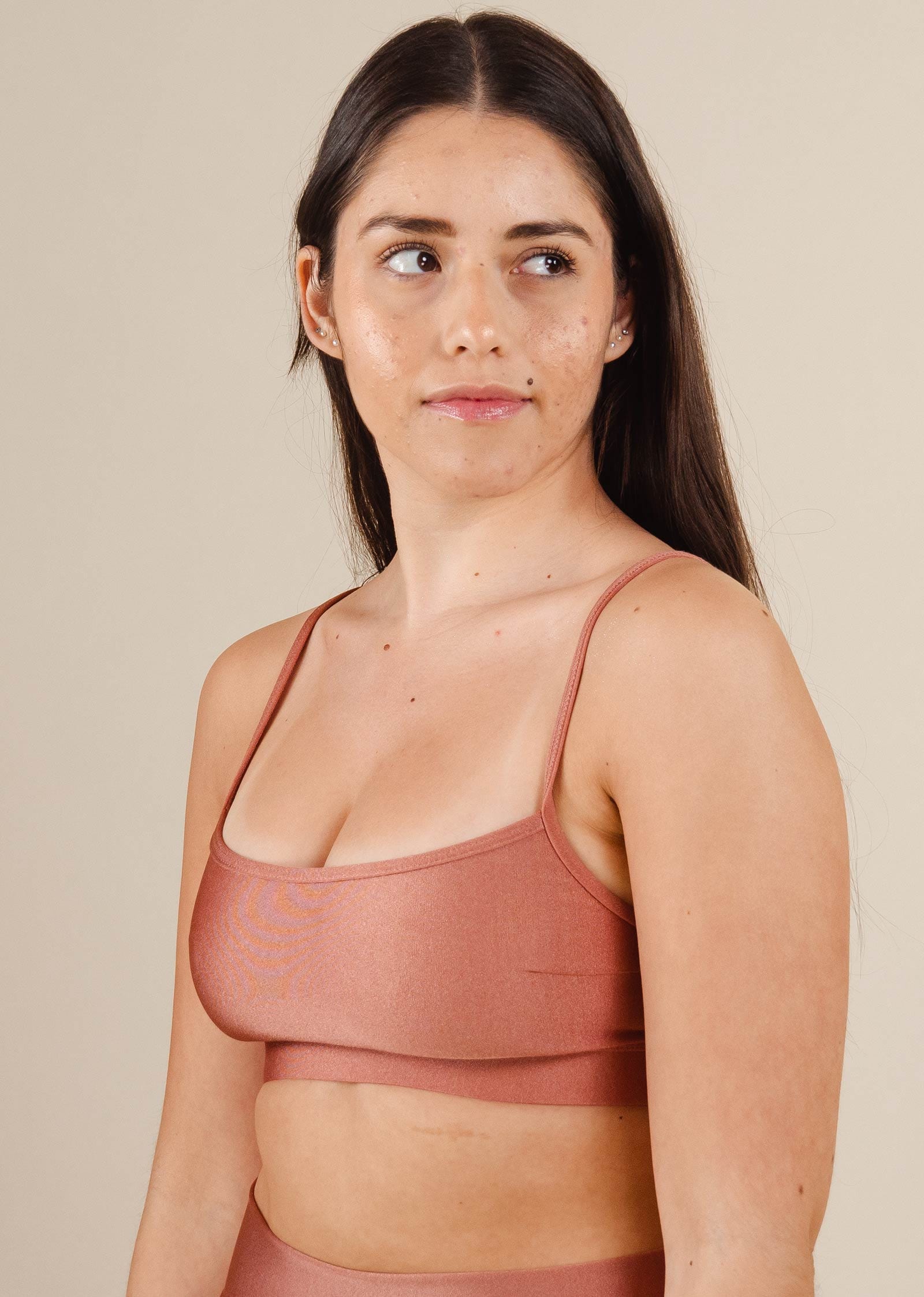 A woman in a Mimi and August Coral Bikini Top Print