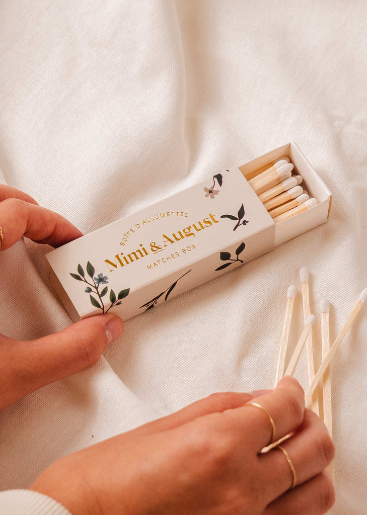 A person holding a Floral Match box with 30 sticks