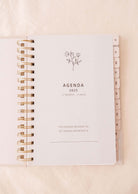 Open the Cafecito - Agenda 2025 by Mimi & August, showcasing a floral illustration on the cover perfect for coffee enthusiasts. This efficient planner includes tabbed monthly dividers on the right side, guaranteeing a fashionable and organized year ahead.