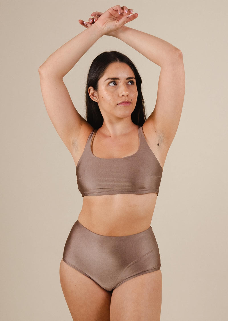 A south american woman wearing the paloma Dunes High Waist Bikini Bottom by mimi and august