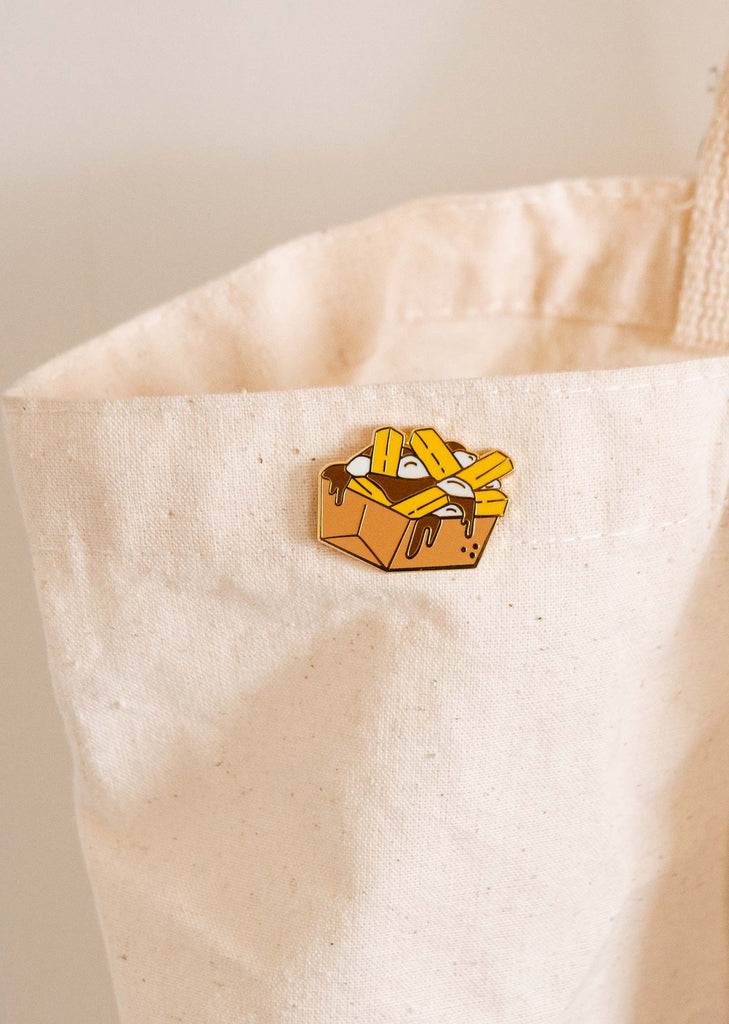 A Poutine in a white tote bag by mimi and august.
