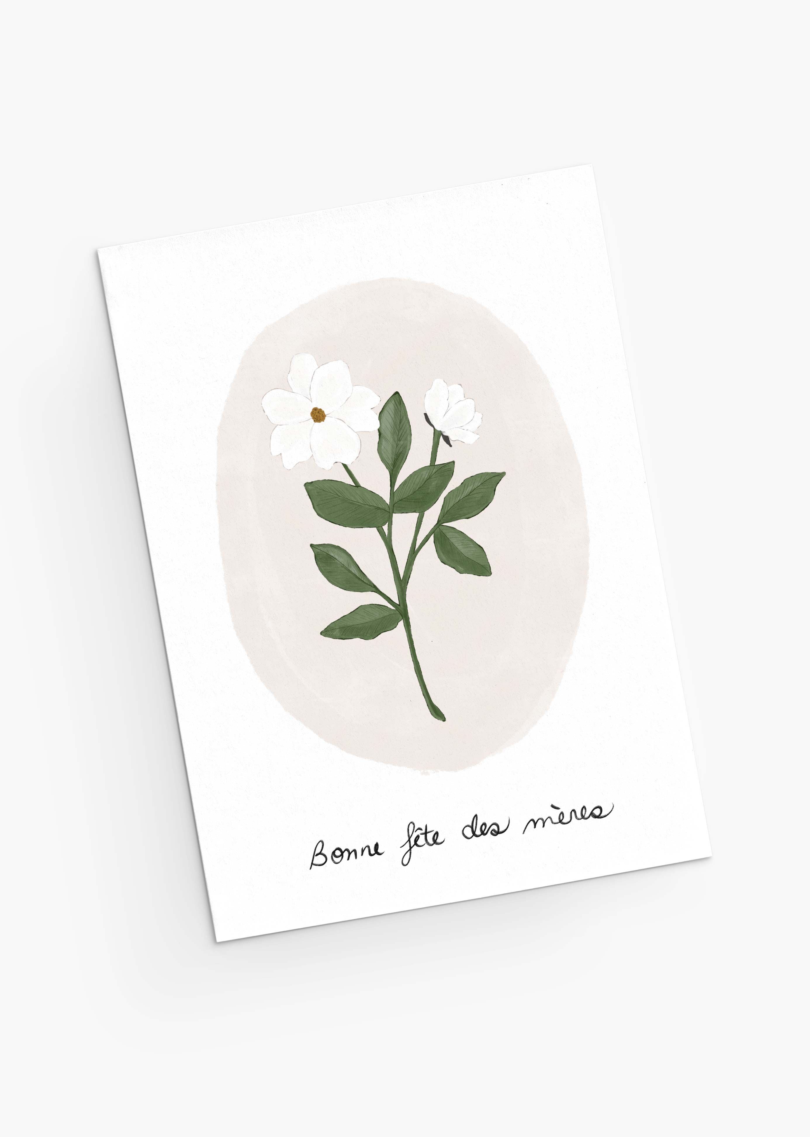 The White Flower Mother's Day Greeting Card from Mimi & August is crafted from recycled paper, featuring a white flower and green leaves illustration with the French greeting "Bonne fête des mères," conveying the delicate charm of pastel blooms.