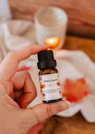 Amber scented oil bottle with autumn forest-inspired fig, cedar, coconut milk, and musk fragrance for diffusers