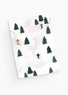 An illustration featuring skiers gliding on a snow-covered slope amidst scattered pine trees, ideal for designing the "Sliding into the Festivities - Christmas Greeting Card" by Mimi & August.