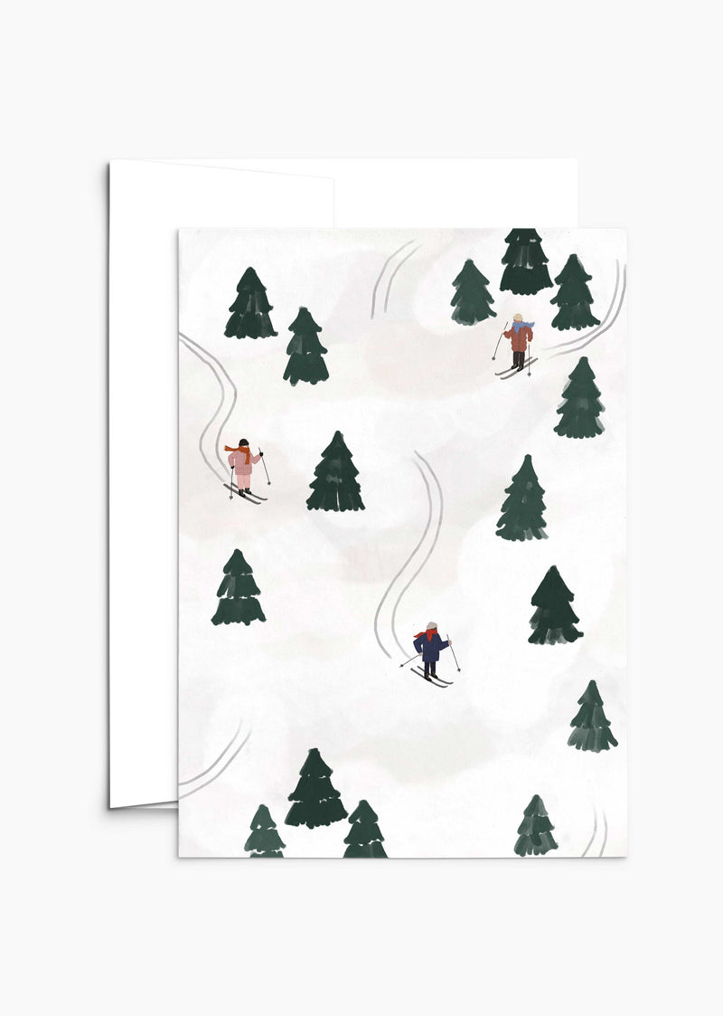 Featuring an illustration of skiers gliding down snowy slopes with green pine trees dotting the landscape, the 'Sliding into the Festivities' Christmas Greeting Card by Mimi & August is perfect for spreading holiday cheer. Enhance your festive greetings by choosing recycled paper and compostable packaging for an eco-friendly touch.