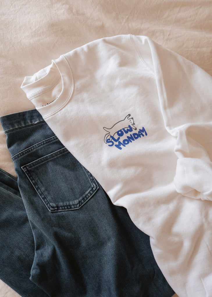 A cozy Slow Monday sweatshirt from Mimi & August with a blue logo on it.