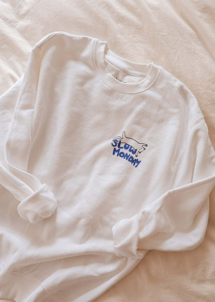 A cozy Slow Monday Sweatshirt from Mimi & August with a blue logo on it.