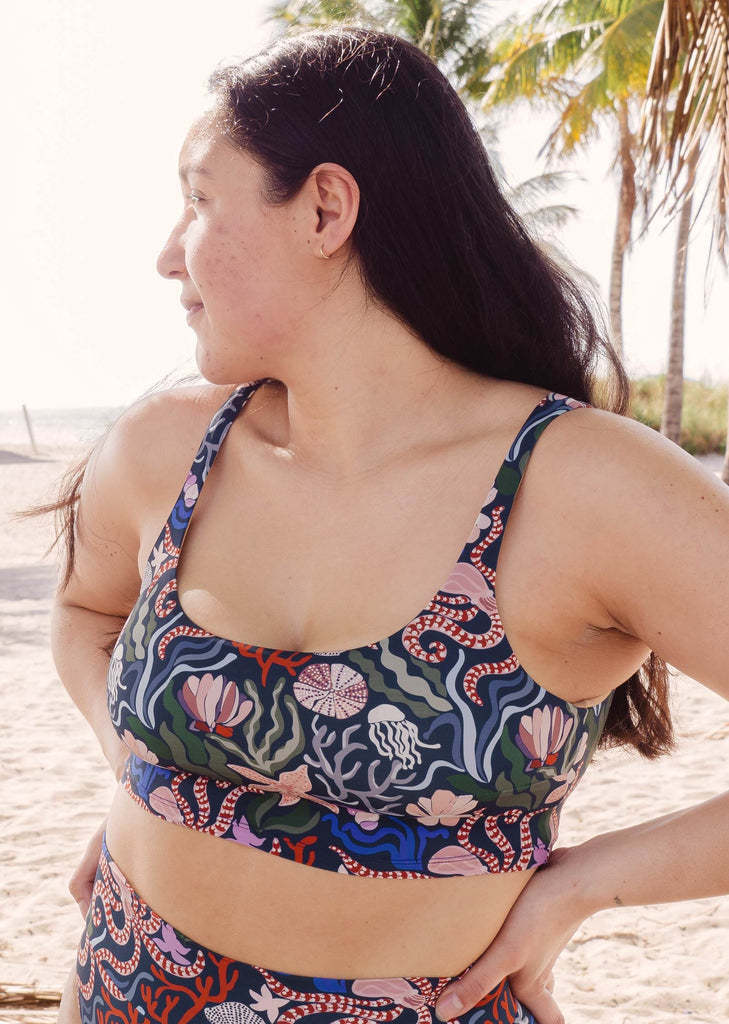 A woman elegantly posing in a Mimi and August Bikini ocean pattern print
