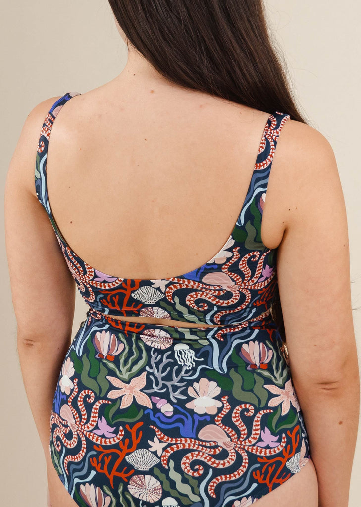 The back of a woman in a Tahiti Oceana Bralette swimsuit by mimi and august.