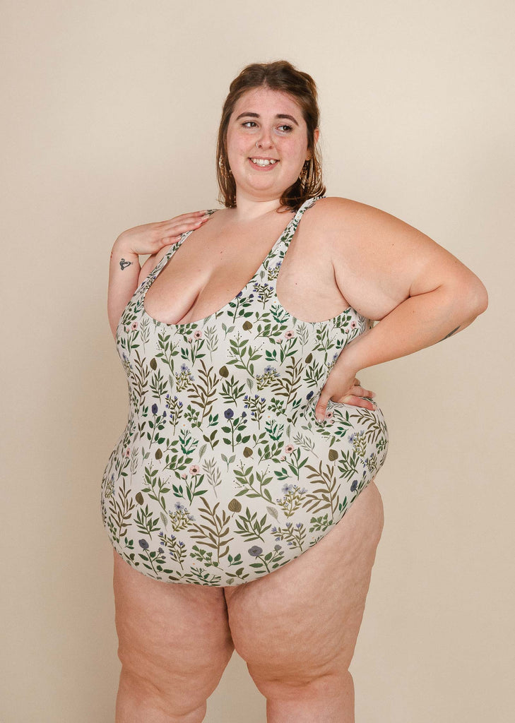 A woman in a mimi and august Scoop Neck One Piece Swimsuit posing for a photo.
