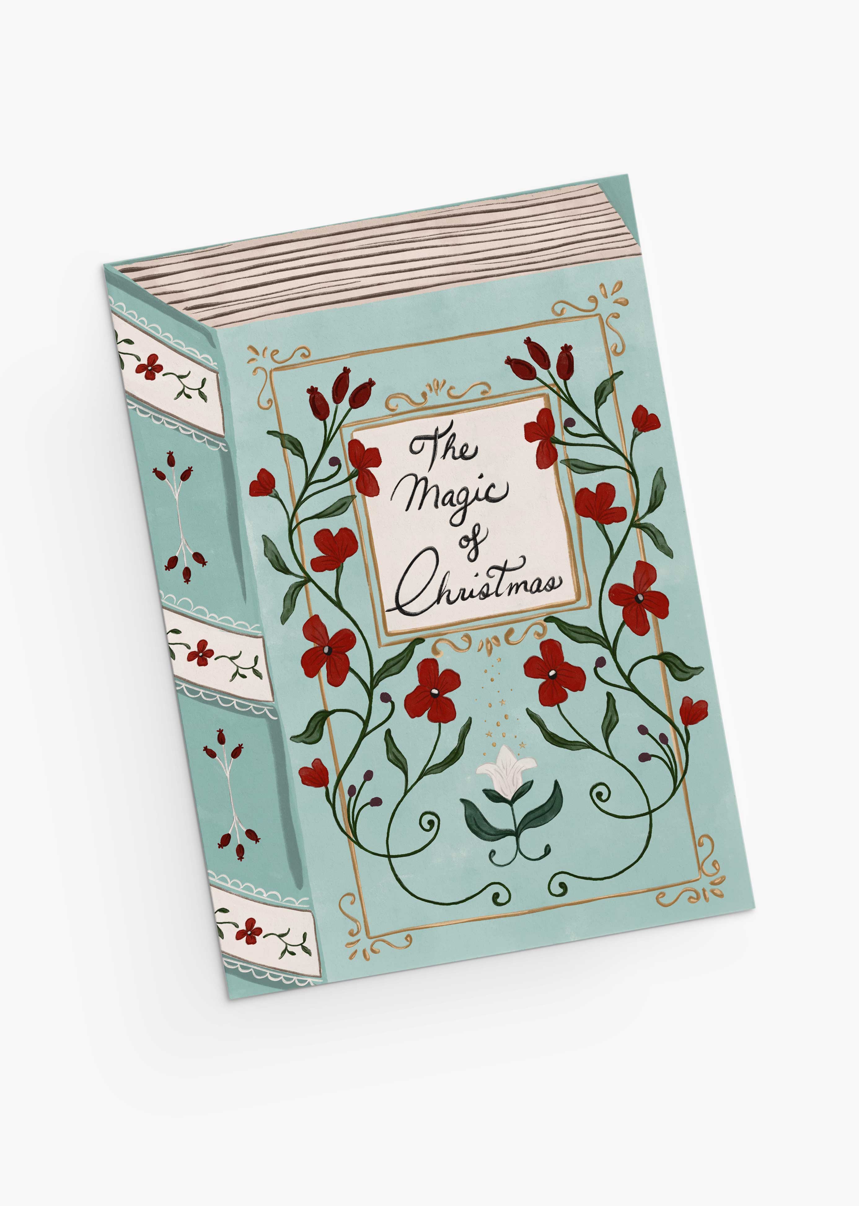A greeting card titled "The Magic of Christmas" by Mimi & August, featuring floral and vine illustrations on a light blue cover and crafted with recycled paper.