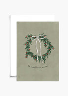 The Best Season Christmas Greeting Card by Mimi & August features an illustrated wreath with red berries and a white ribbon on green, "la meilleure saison" text, is blank inside, and printed on recycled paper.