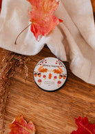 2 oz amber candle with fig, cedar, coconut milk, and musk scent in a glass container