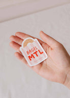 Bagel MTL vinyl sticker with playful Montréal bagel design, durable and weatherproof.
