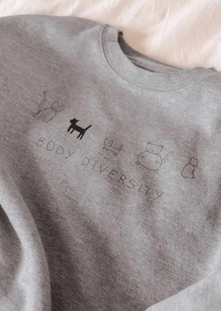 A comfortable Mimi & August Body Diversity Sweatshirt featuring the phrase "body diversity.