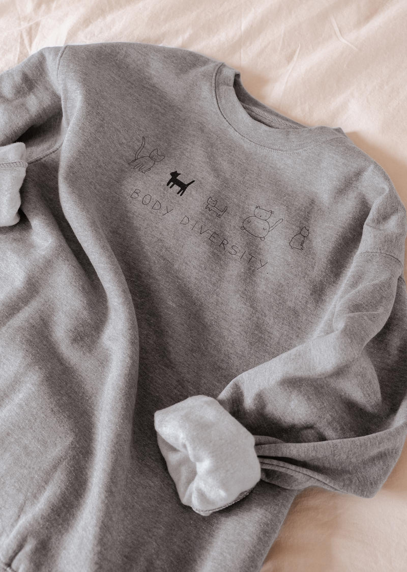 A comfortable Body Diversity Sweatshirt by Mimi & August with an image of many cats