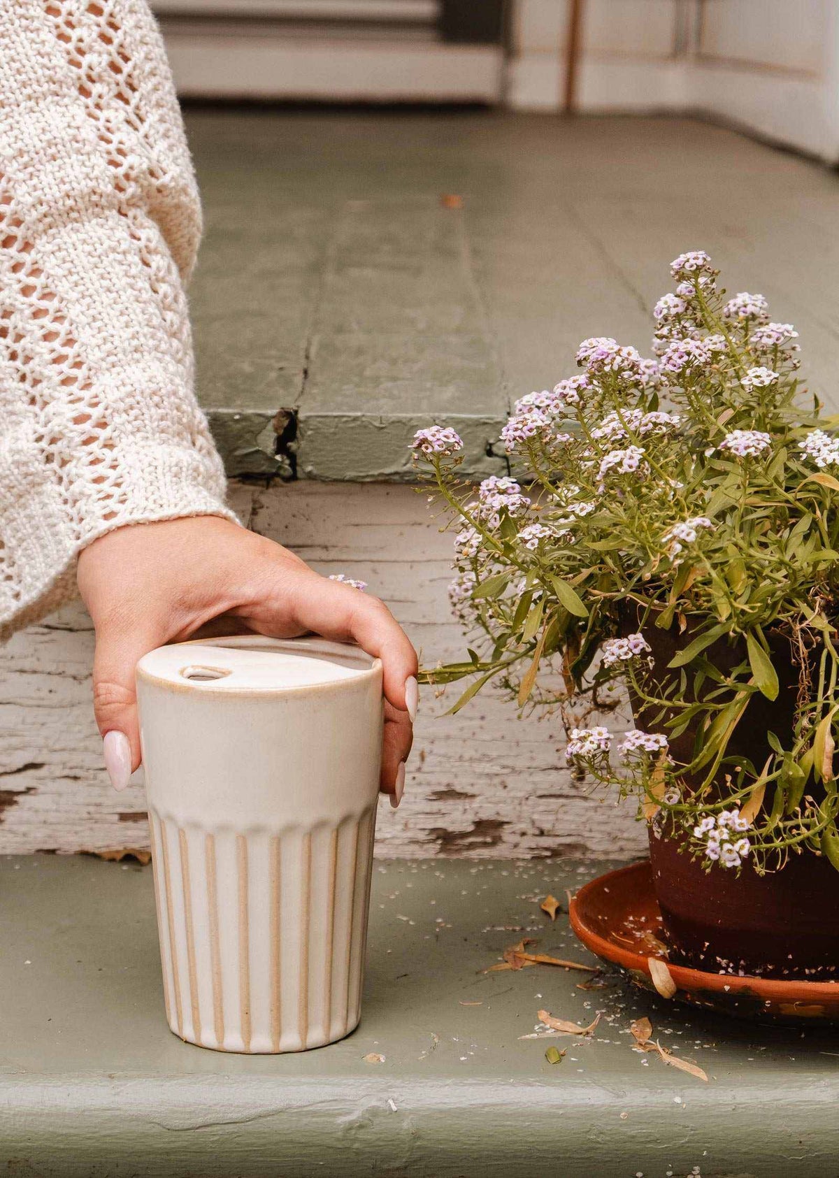 Handmade ceramic to-go cup with ribbed grip and fitted lid