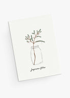 The Mimi & August Christmas Tree Branch Greeting Card features a festive branch in a glass jar and “Joyeuses fêtes” text, is blank inside for your message, and printed on recycled paper.