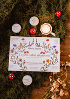 Fall candle gift set with six soy tealights, floral illustrated box, and seasonal mushroom details