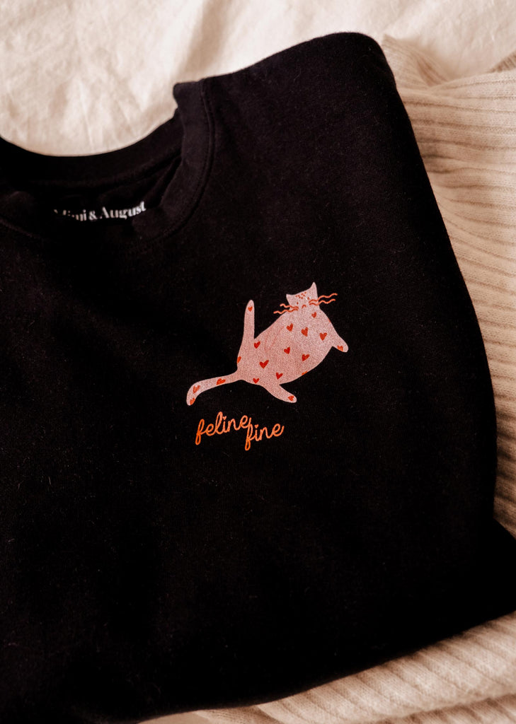 A "Feline Fine Sweatshirt" by Mimi & August with a cat on it.