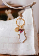 Floral cat keychain with pink flower and gold brass finish