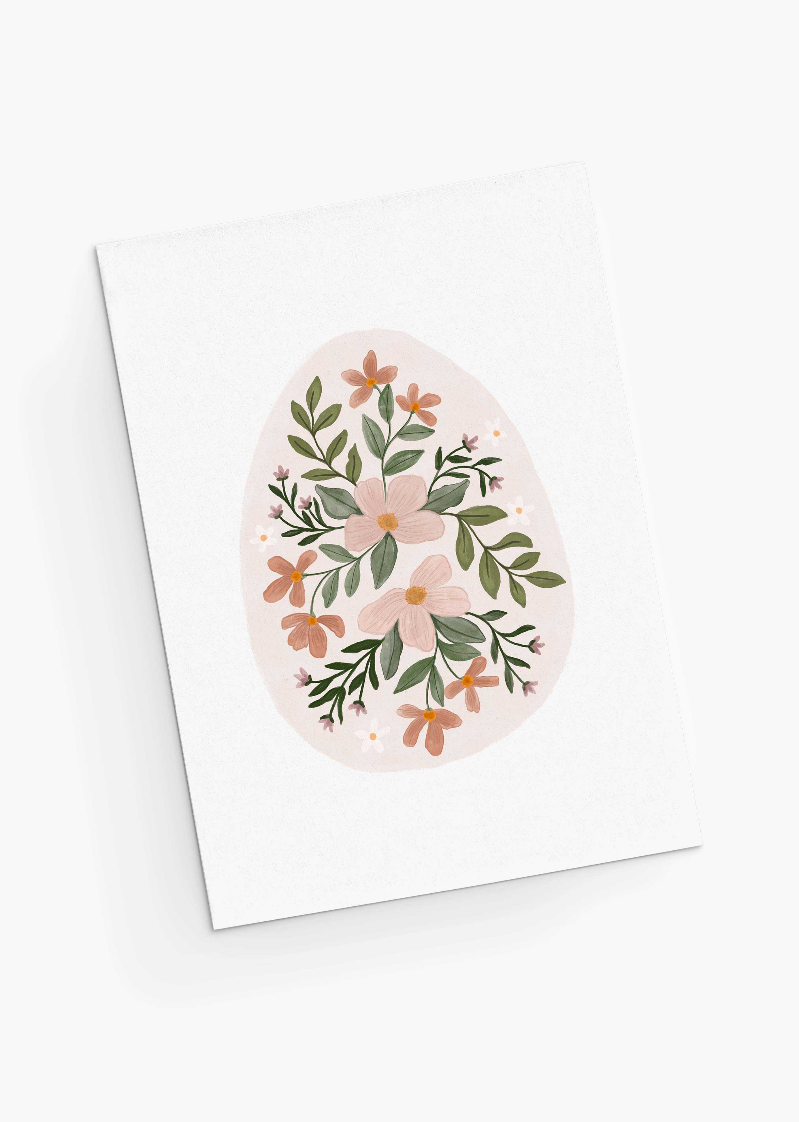 The Floral Egg Greeting Card by Mimi & August showcases pink and orange flowers with green leaves and white accents in an egg shape against a white background. Ideal for Easter, it's crafted on recycled paper.