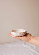Handcrafted little ceramic candle holder nest with minimalist design and textured surface