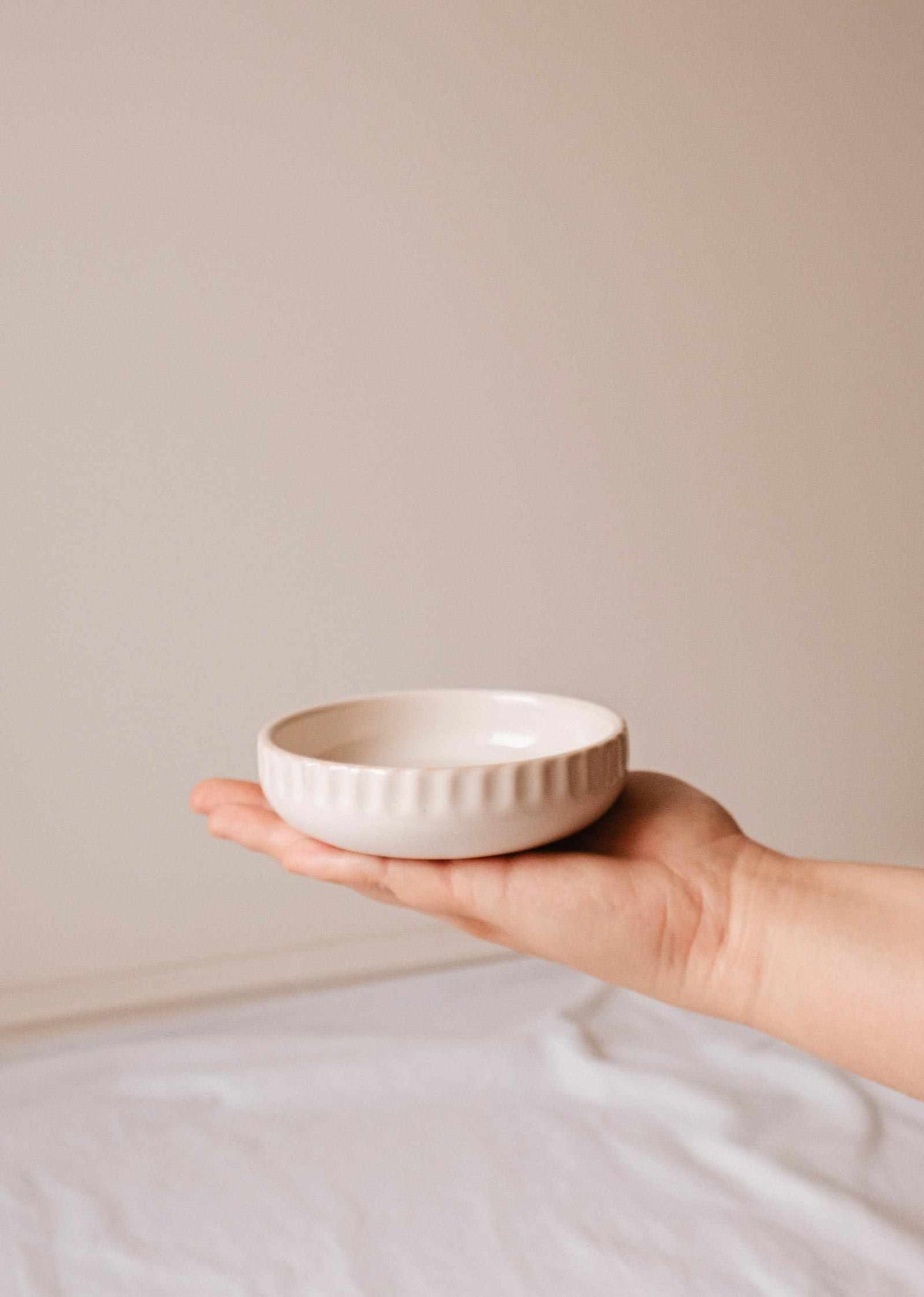Handcrafted little ceramic candle holder nest with minimalist design and textured surface