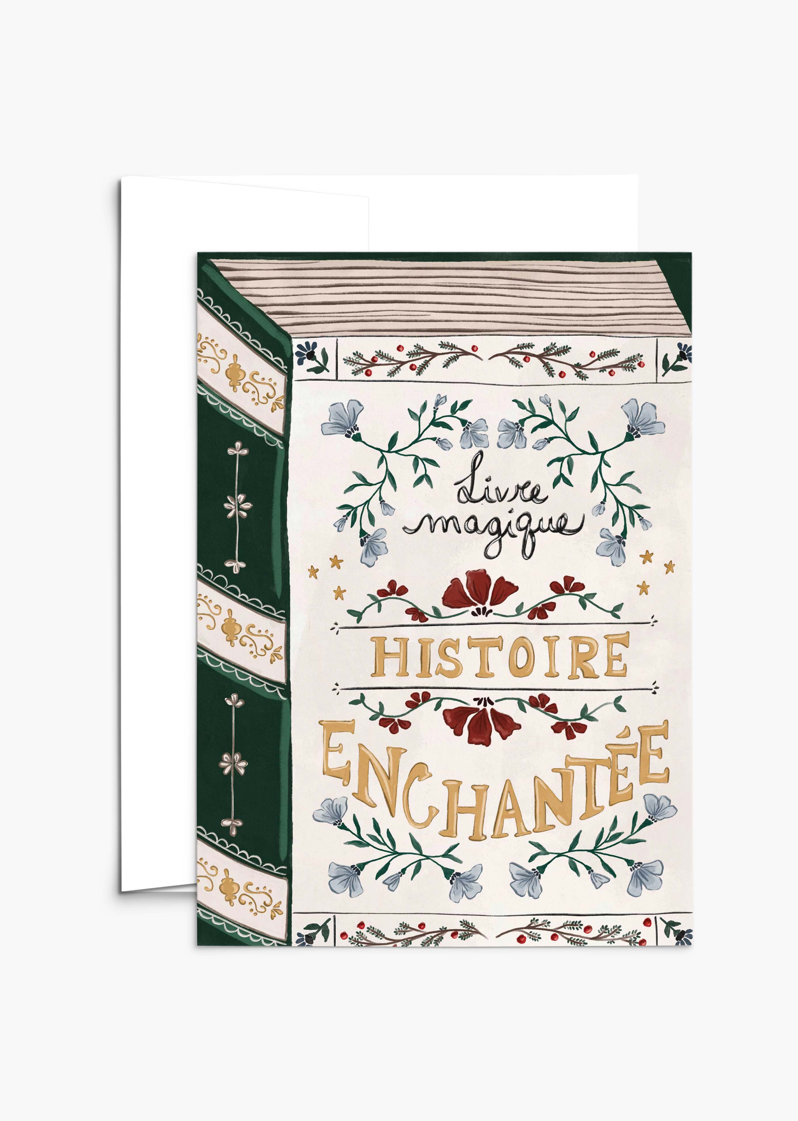 The Enchanted Book Christmas greeting card by Mimi & August features a vintage book cover design with floral accents and French text, "livre magique Histoire Enchantée," printed on recycled paper for an eco-friendly touch.