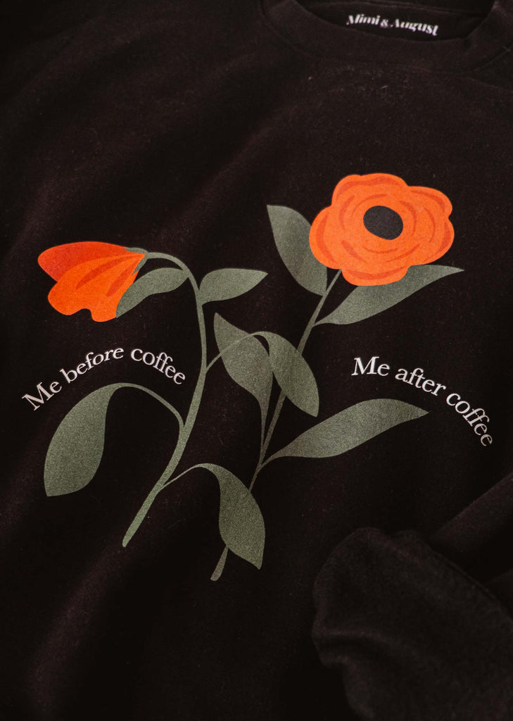 A comfortable Me Before My Coffee sweatshirt with orange flowers on it by Mimi & August.