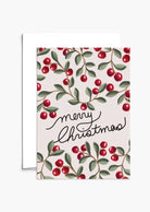 The Merry Christmas Greeting Card by Mimi & August features "Merry Christmas" in cursive with red berries and green leaves on a light background. Printed on recycled paper, it's blank inside for your message.