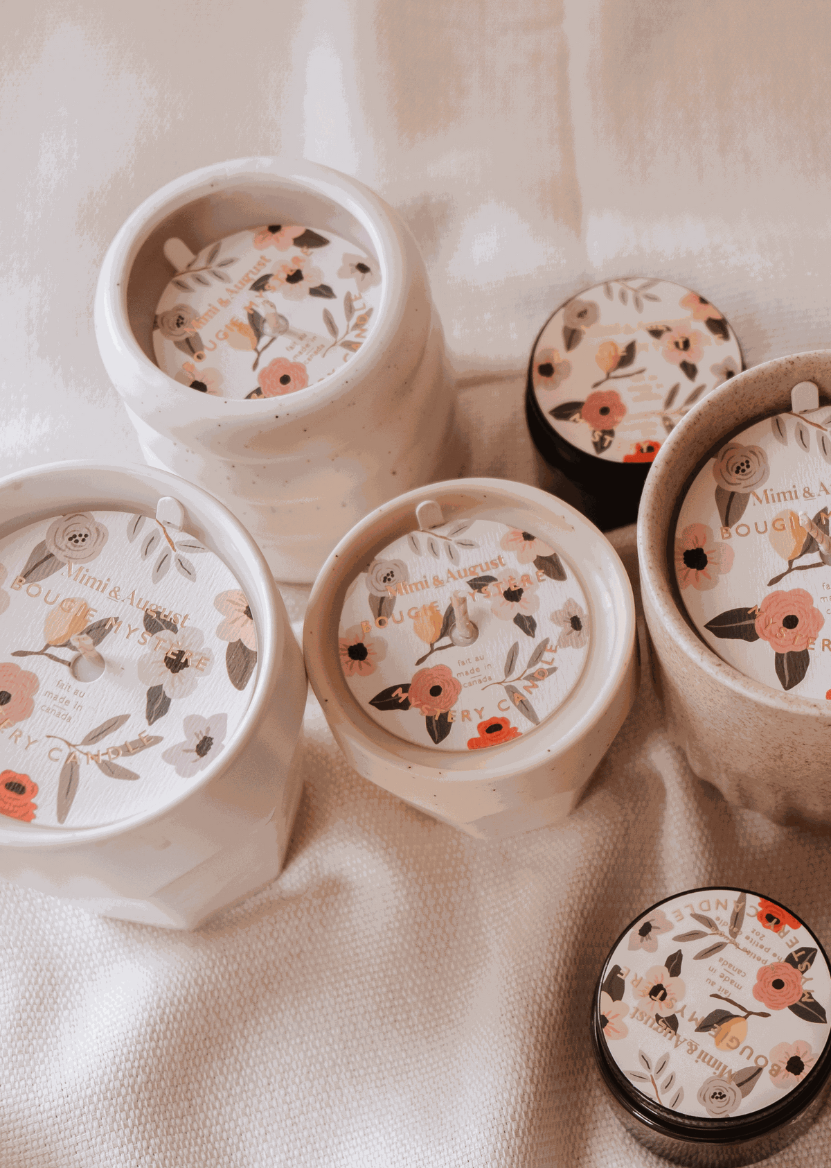 A set of Mystery Candles by Mimi & August, with enchanting floral designs, available in limited quantity.