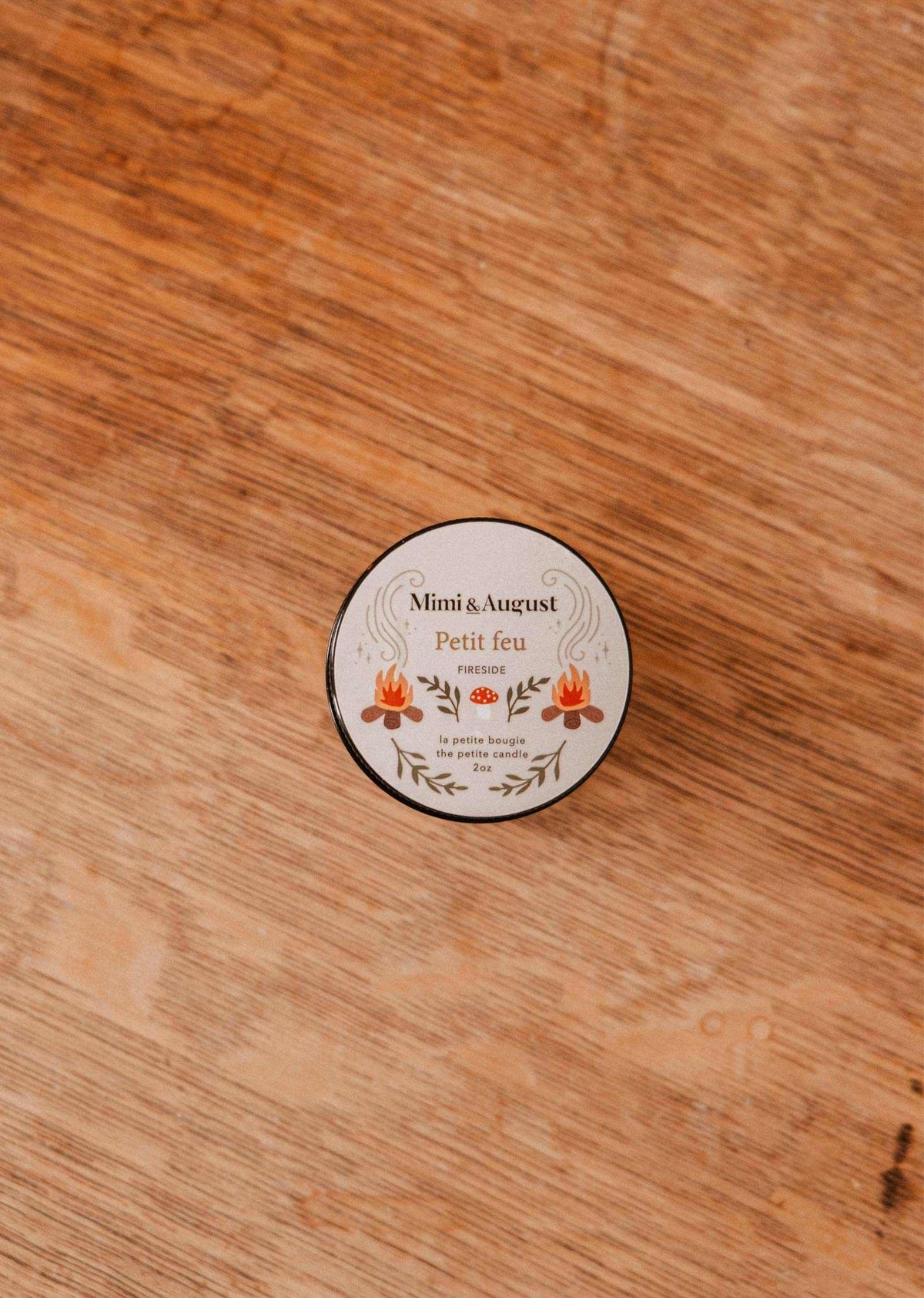 The Mimi & August Petit Feu – 2 oz Soy Candle features a floral tin, coffee scent, and reusable design—perfect for any space.