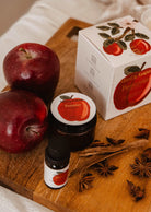 2 oz apple cinnamon candle in glass jar with warm autumn scent
