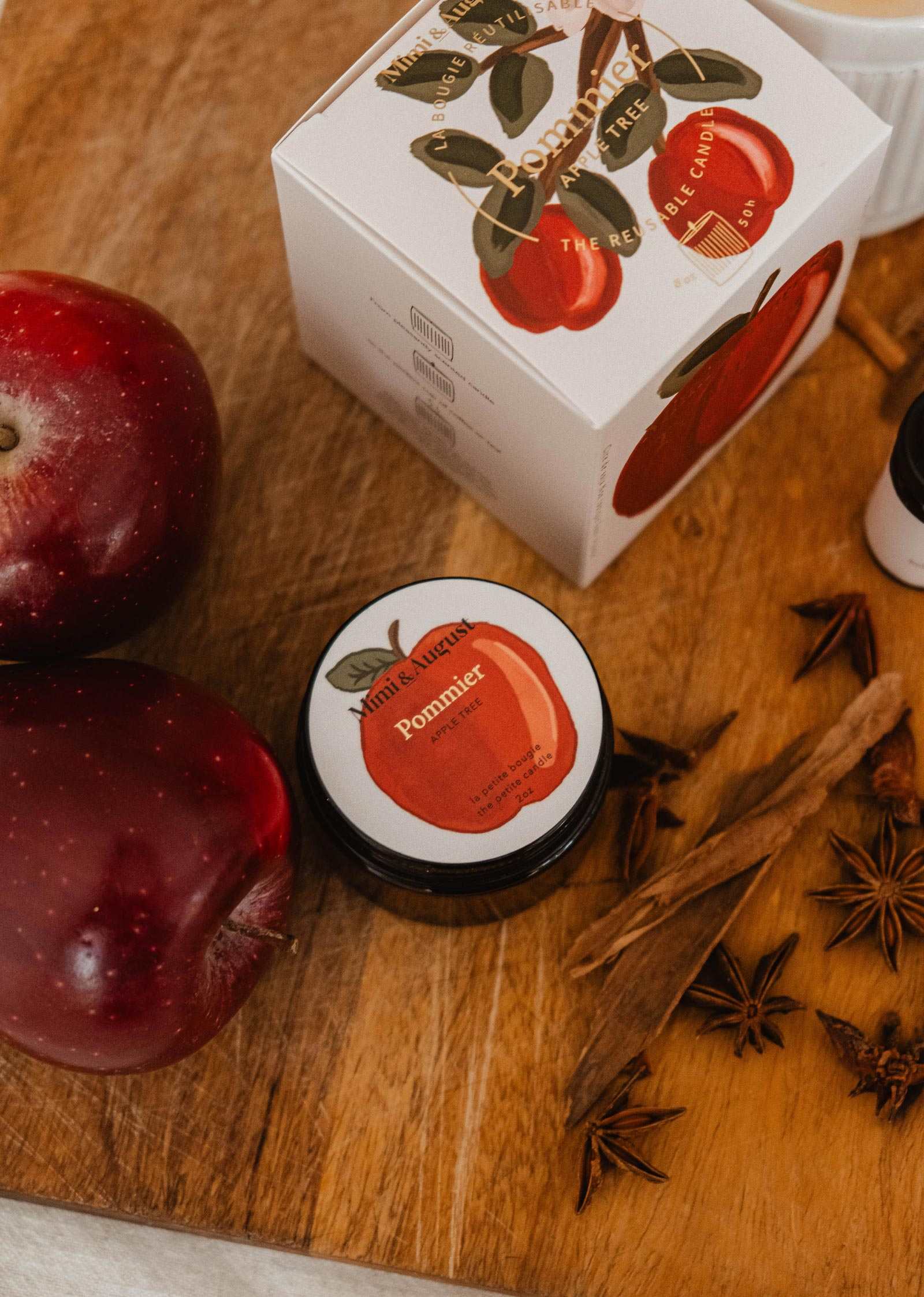 2 oz Pommier apple cinnamon candle in glass jar with warm autumn scent