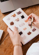 Softcover purr-fect cat notebook with 100 lined pages and playful kitty faces cover