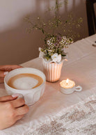 Handcrafted wavy tealight holder ceramic cup with toasted-brown rim and handle
