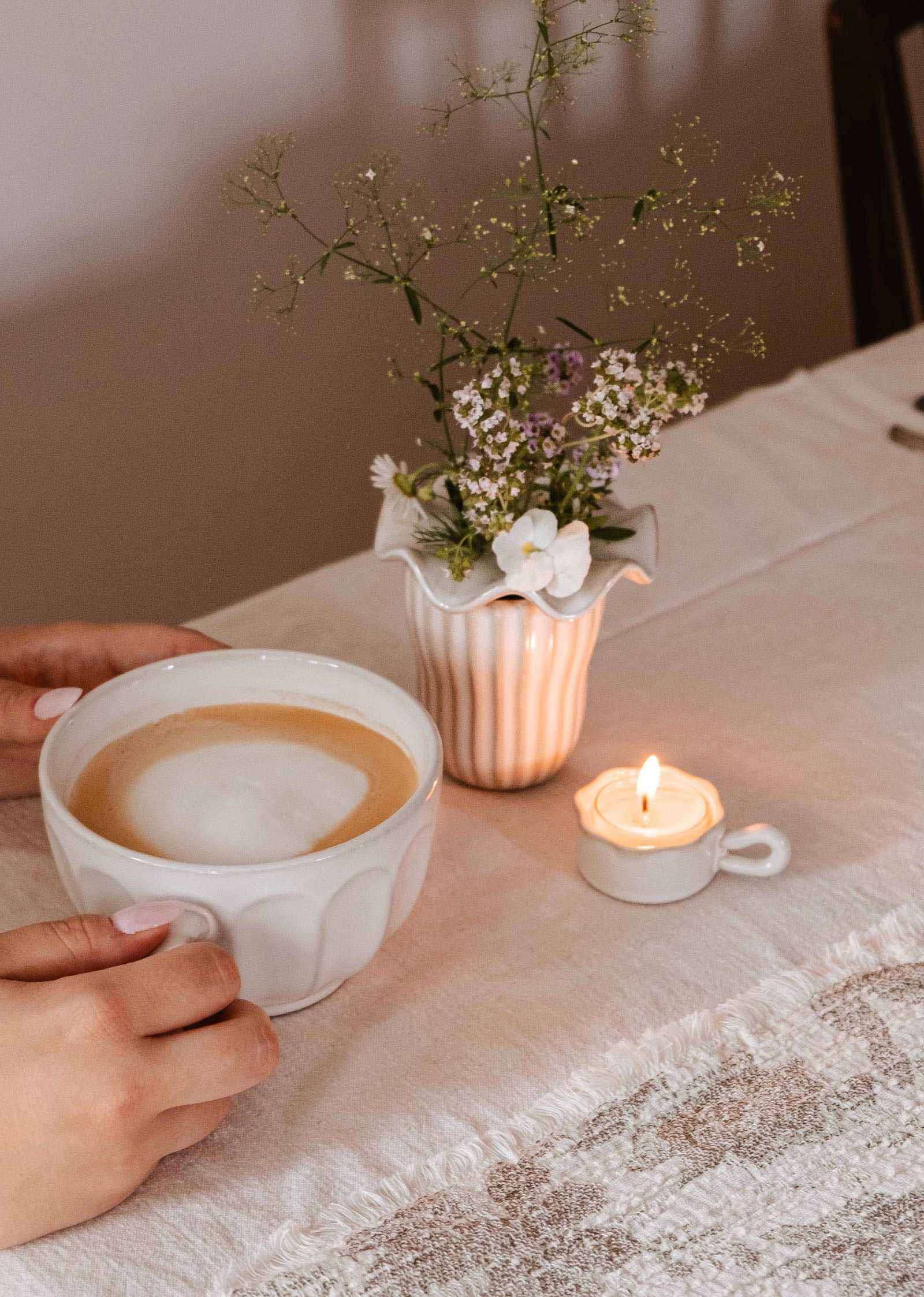 Handcrafted wavy tealight holder ceramic cup with toasted-brown rim and handle