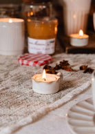 Handcrafted ceramic wavy tealight holder with toasted-brown rim and handle