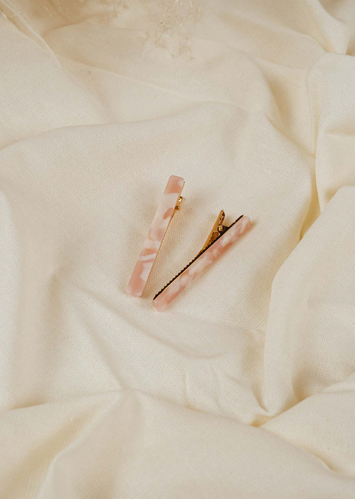 ivory hair clip in the shape of pink and white color bars with gold clips