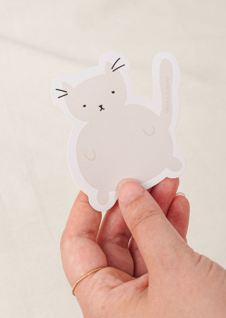 Grey cat vinyl sticker in a hand