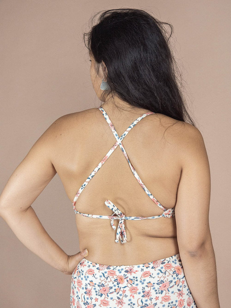 The back view of a woman wearing the Mimi & August Chichi Amour Bralette Bikini Top from her swimwear collection.