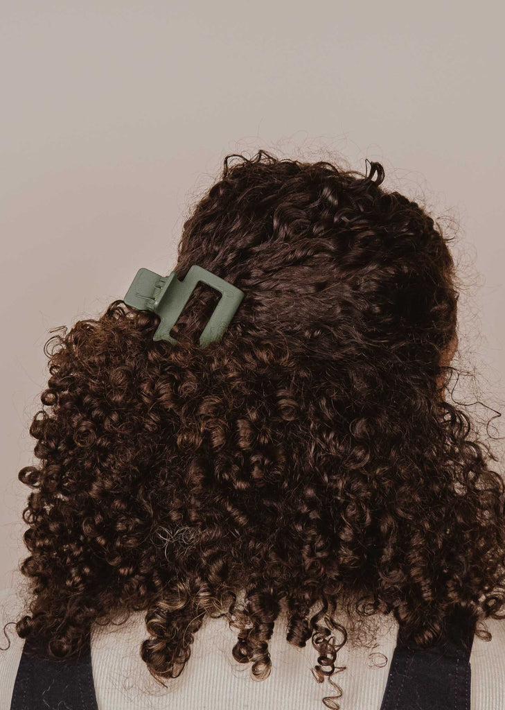 Mini Forest Green hair claw in curly hair 