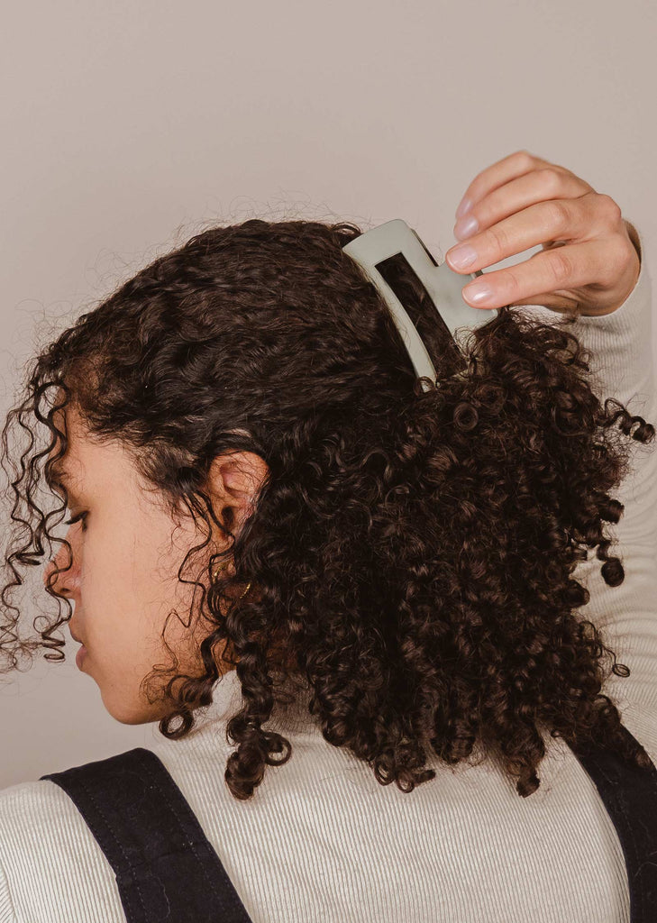 Laura using the large Iris hair clip on her curly hair