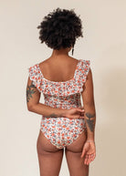 Dos d'Aline portant le maillot une-piece floral milano