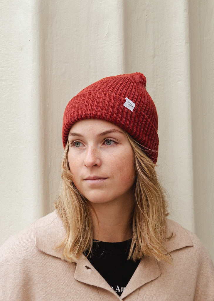 woman smiling and wearing the picante beanie