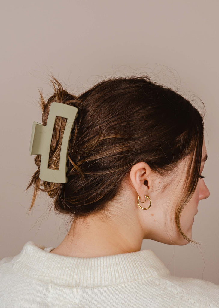 Sage Green color Claw Clip Barrette attached to a brown hair 